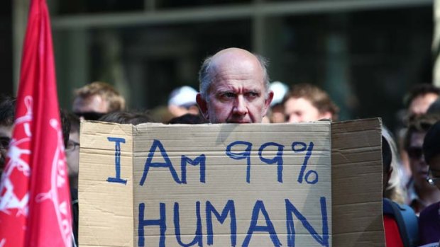 Figure of discontent ... a protester holds up a placard at the Occupy Sydney rally.