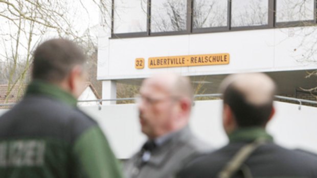 Police officers stand in front of the Albertville school in Winnenden near Stuttgart, Germany.