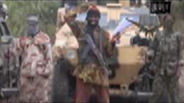 A still from a video that shows the leader of the Islamist extremist group Boko Haram Abubakar Shekau (centre) threatening to sell hundreds of girls his group abducted from a Chibok school in northern Nigeria.