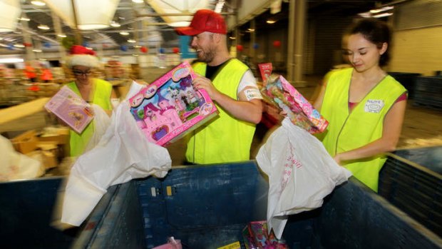 Helping hands: Sorting toys for the Smith Family.