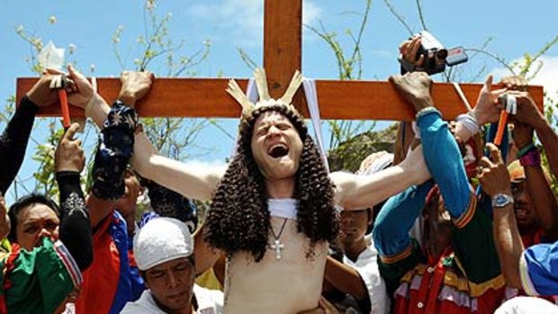 Australian 'John Michael' has his hands nailed to the cross in an imitation of Christ's death as part of Good Friday rituals just outside Manila.