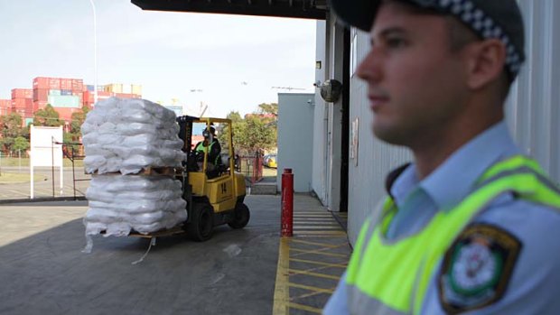 Police seize white powder as part of counterfeit arrests.