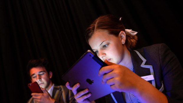 Teenagers spending too much time on electronic devices is raising concerns about inactivity and obesity. Sienna Withington and Daniel Marks using their devices.