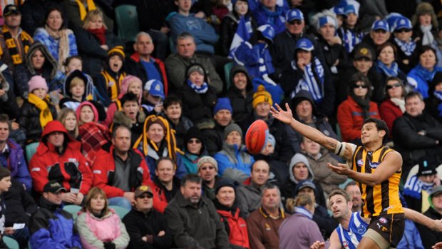 Hands up: Hawk Cyril Rioli and Roo Brady Rawlings battle for the ball at Aurora Stadium last year.