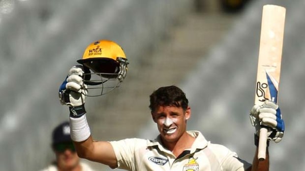 Michael Hussey celebrates his timely ton at the MCG yesterday.