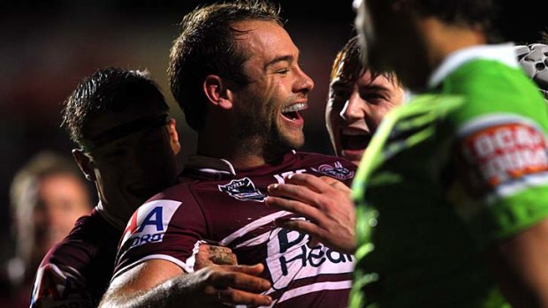 Riding high ... Manly fullback Brett Stewart celebrates one of his three tries against Canberra at Brookvale Oval on Monday night with teammates.