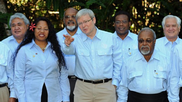 Delegates, including Kevin Rudd, wear their official light blue shirts before the start of the leaders' retreat at the 40th Pacific Islands Forum summit in Cairns.