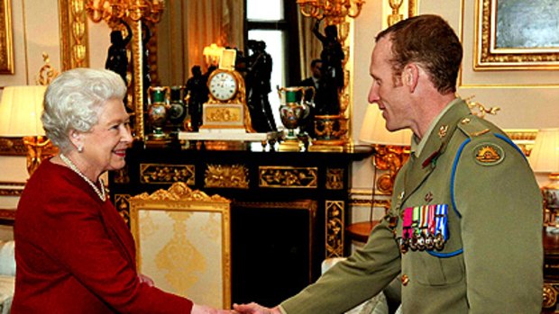 Victoria Cross recipient Mark Donaldson meets the Queen at Windsor Castle.