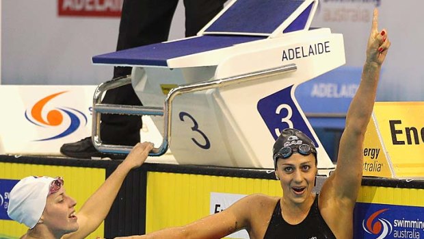 London bound: Stephanie Rice celebrates victory ahead of Alicia Coutts in the 200 metres medley final last night.