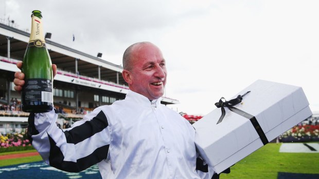 Fond farewell: Jockey Jim Cassidy poses with gifts presented to him at Flemington Racecourse on November 5.