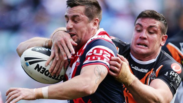 Going nowhere ... Mitchell Pearce of the Roosters is tackled by Chris Heighington.