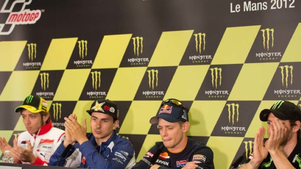 The MotoGP riders applaud Casey Stoner of Australia and Repsol Honda Team after the announcement of his retirement at the end of this season.