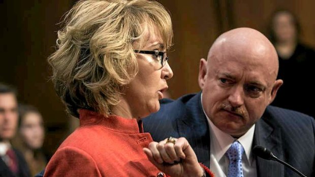 Gabrielle Giffords speaks during a hearing of the Senate Judiciary Committee  in Washington as her husband Mark Kelly looks on.