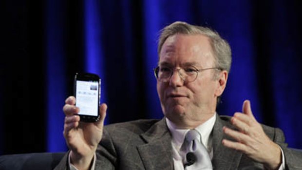 Google CEO Eric Schmidt holds a prototype of the Android Gingerbread smartphone during the Web 2.0 Summit in San Francisco, California November 15, 2010.