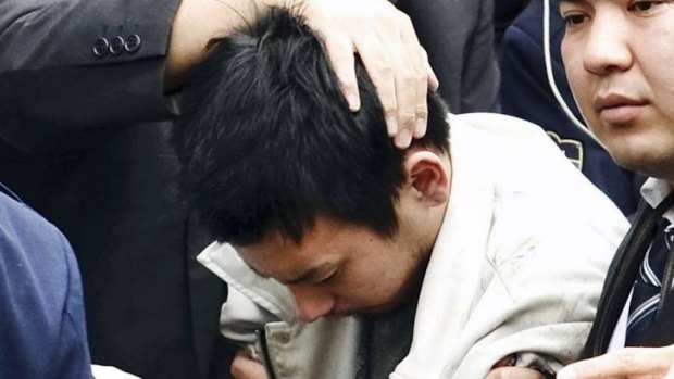 Capture: Rape suspect Yuta Sugimoto, centre.