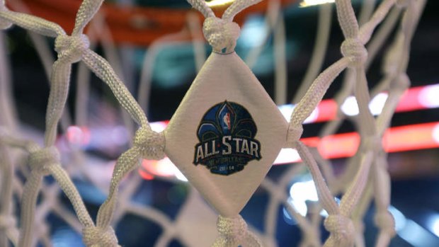 The NBA All-Star logo is affixed to a net as workers prepare the Smoothie King Center for the NBA All-Star events, which run through the end of the week in New Orleans.