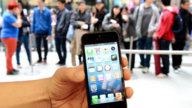 People queue to buy Apple's new iPhone 5 from their flagship store in Sydney.