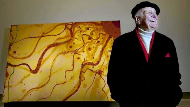 Painter John Olsen with one of the eight panels of <i>The King Sun</i> erected in Collins Square.