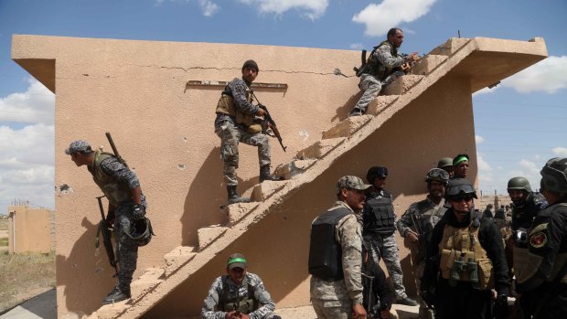 Iraqi security forces and allied Shiite militiamen prepare to attack Islamic State extremists in Tikrit.
