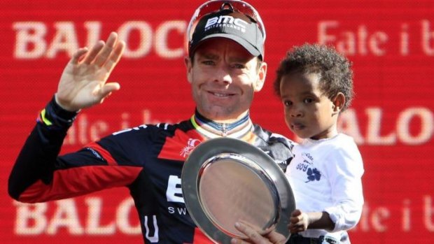 Making history: Cadel Evans celebrates a place on the podium in 2013 with his son Robel.