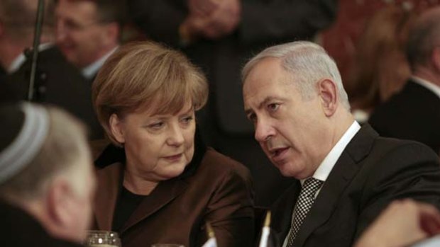 Benjamin Netanyahu sits next to German Chancellor Angela Merkel during a dinner in Jerusalem last week.
