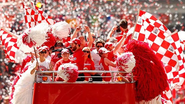Celebration: Sydney Swans fans celebrate winning last year's grand final but the weight of history and statistics are against a repeat.
