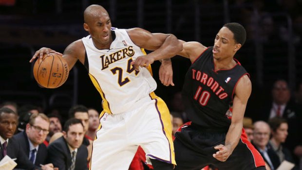 Los Angeles Lakers guard Kobe Bryant is defended by Toronto's DeMar DeRozan on Sunday.  It was Bryant's first game back after a torn left Achilles tendon injury.