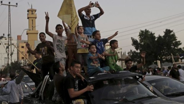 Palestinians waving the Fatah flag celebrate the ceasefire in the northern Gaza Strip.