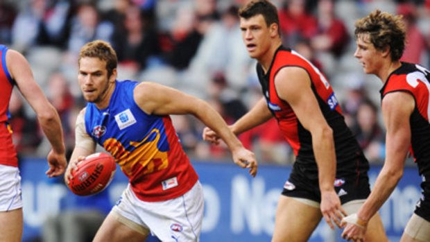 Jared Brennan (left) in action for the Lions against Essendon in season 2010.