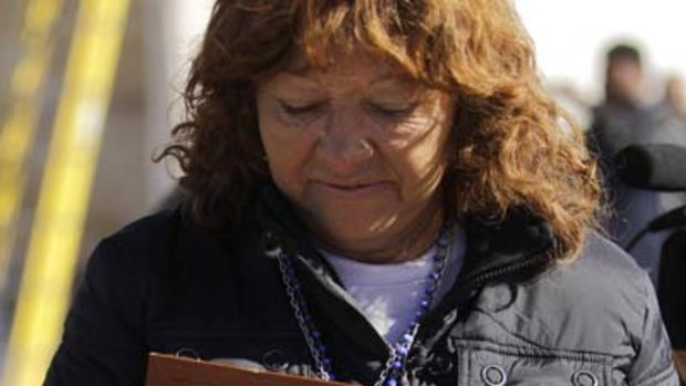 Lilianette Ramirez, wife of miner Mario Gomez, holds the first letter retrieved from her husband who is trapped in the collapsed San Jose mine.