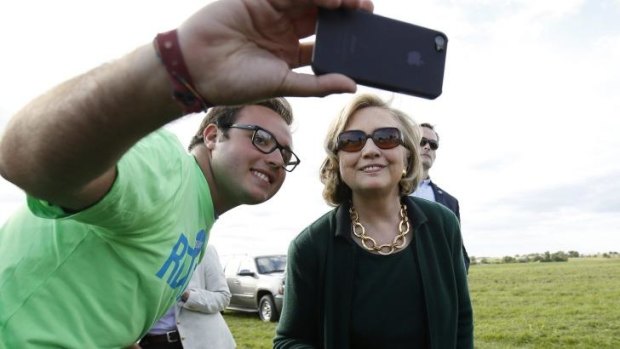 Selfie time with a fan: Mrs Clinton with a supporter at the Harkin steak fry in Iowa.