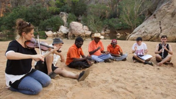 Sydney Symphony Orchestra members gather at Windjana Gorge to practise a piece.