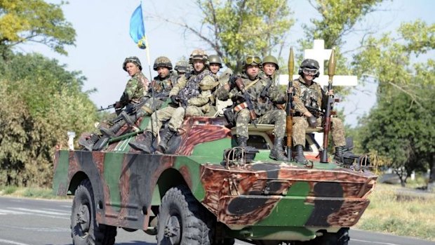 Ukrainian servicemen of volunteer battalion Azov ride on their APC towards the small Ukrainian city of Novoazovsk, in the Donetsk region.