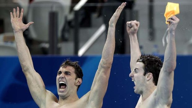 Matthew Targett and James Magnussen (right) of Australia celebrate winning the gold medal in the Men's 4x100m Freestyle Relay.