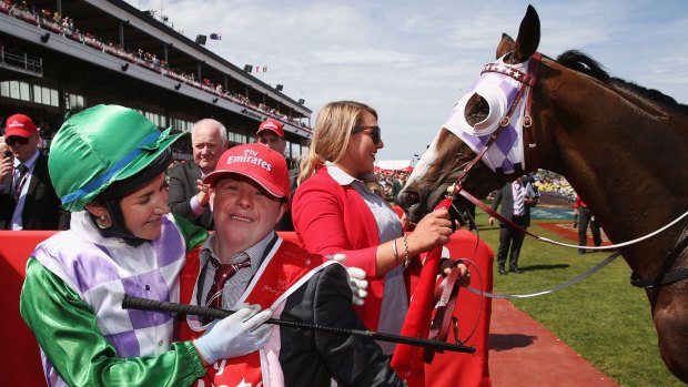 Michelle Payne celebrates her winning ride on Prince Of Penzance to win race 7 the Emirates Melbourne Cup with brother and strapper Stephen Payne on Melbourne Cup Day.