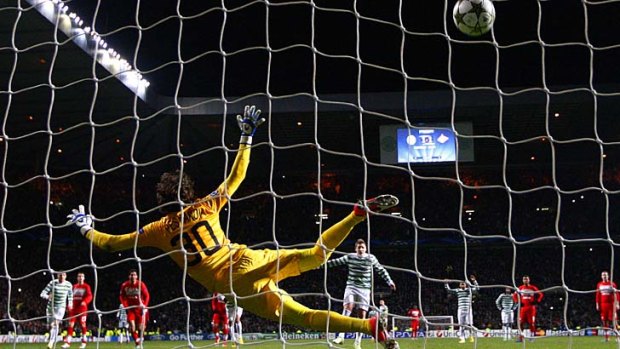 Cock-a-hoop &#8230; Kris Commons thumps home the penalty to send Celtic through to the knockout phase of the Champions League.