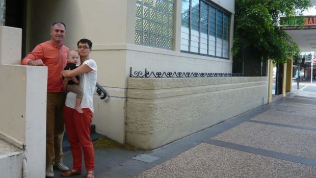 Darren Godwell, his partner Seleneah and their 15-month-old son outside their South Brisbane unit.