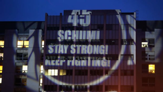 Get well soon: Michael Schumacher fans projected their message on to the hospital in Grenoble, France, where the former driving ace is being treated.