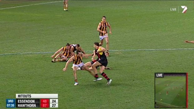 Hawthorn's Luke Hodge sticks out his leg and makes contact with Essendon's Paddy Ryder.