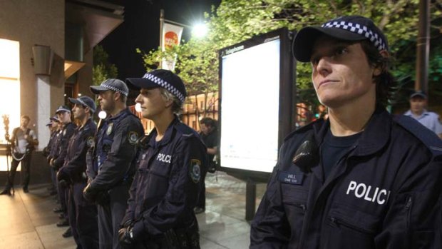 Police stand at the ready as Occupy Sydney protesters camp in Martin Place last night.