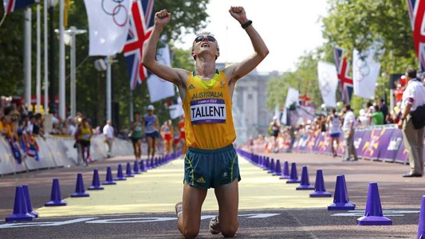 Australia's Jared Tallent falls to his knees after crossing the finish line.