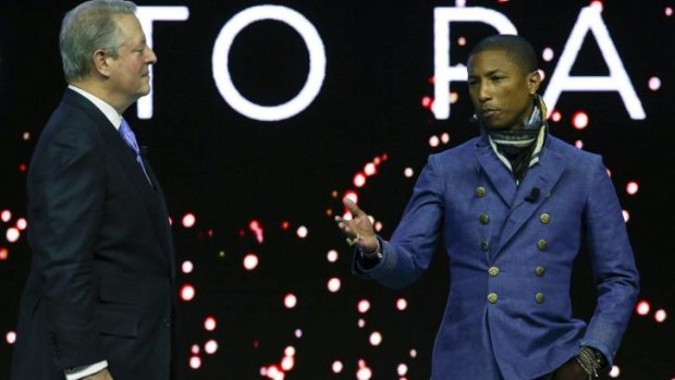 Former US vice-president Al Gore and <i>Happy</i> singer Pharrell Williams announce the concert at Davos.