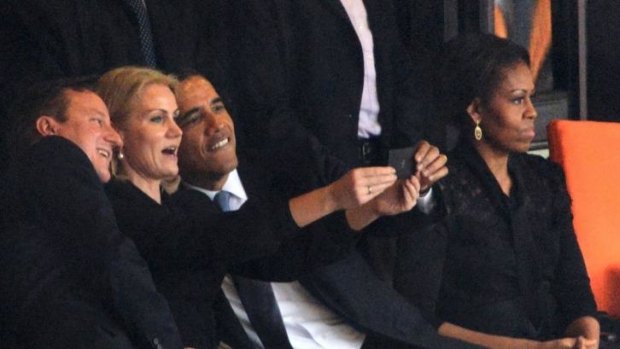 Barack Obama and David Cameron take a "selfie" with Danish PM Helle Thorning-Schmidt, but Michelle Obama seems less than amused.