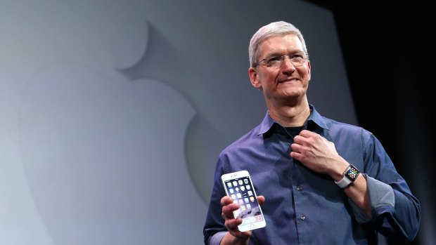 Apple CEO Tim Cook holds the new iPhone 6 Plus.