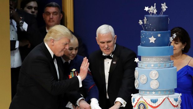 President Donald Trump and Vice-President Mike Pence cut the cake.