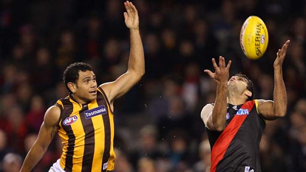 Battle royale: Hawk Cyril Rioli and Bomber Courtenay Dempsey in action at Etihad Stadium last year.