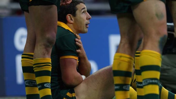Down and out: Billy Slater nurses his collarbone after a tackle.