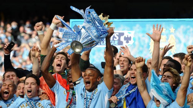 We are the champions ... Manchester City's captain Vincent Kompany lifts the Premier league trophy