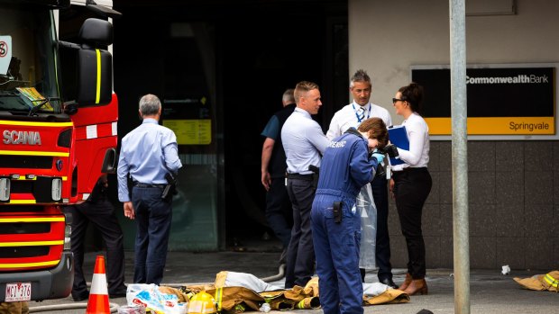 Evidence is recorded at the scene of the Commonwealth Bank fire in Springvale.