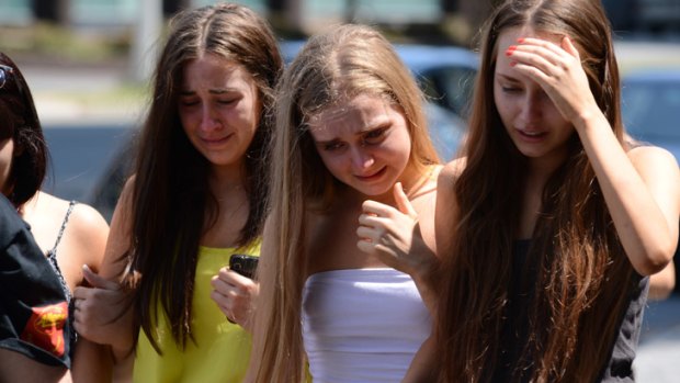 Schoolies console each other outside the Chevron Renaissance.